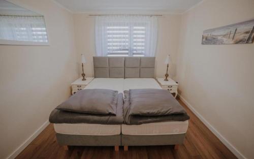 a bedroom with a large bed in a white room at Beskidzka Oaza in Targanice