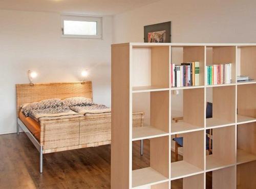 a bedroom with a bed and a book shelf at Casa Fortuna Bodensee in Lindau-Bodolz