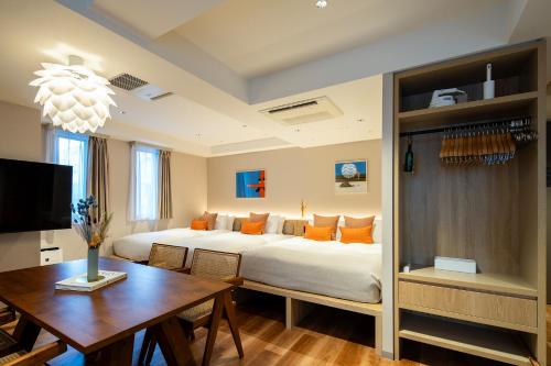 a large bedroom with a large bed and a desk at Section L Shimbashi West in Tokyo