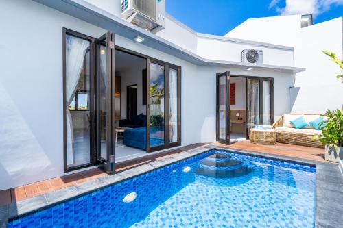 a swimming pool in a villa with a house at The Peak 8 Nusa Dua in Nusa Dua
