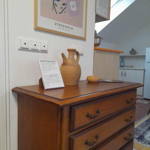 a wooden dresser with a vase on top of it at Villa Sabic in Sarajevo