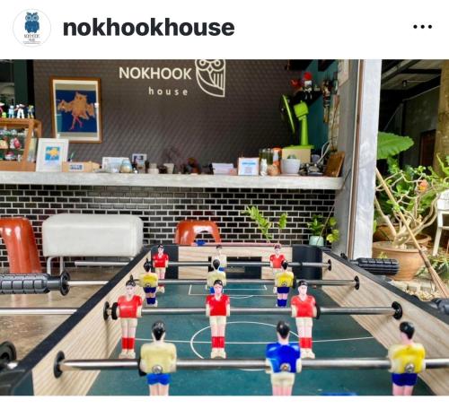 a group of lego people on a pool table at Nokhook House in Trang