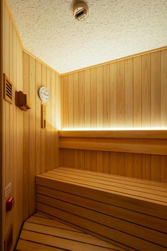 a sauna with a clock on the wall at Section L Shimbashi West in Tokyo