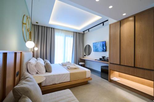 a hotel room with a bed and a tv at Monarco Executive Rooms in Rhodes Town