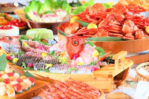 a buffet of different types of seafood on a table at Matsunoyu in Matsue
