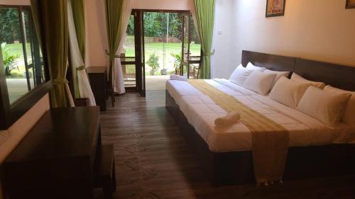 a bedroom with a large bed with white pillows at Villa D55 in Kandy
