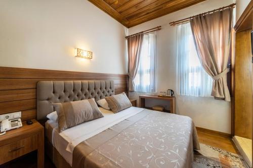 Postel nebo postele na pokoji v ubytování Armistis Hotel
