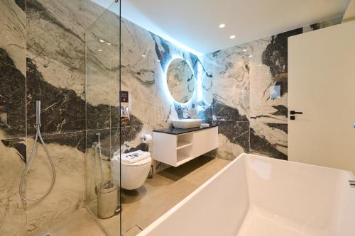 a bathroom with a shower and a toilet and a sink at Monarco Executive Rooms in Rhodes Town