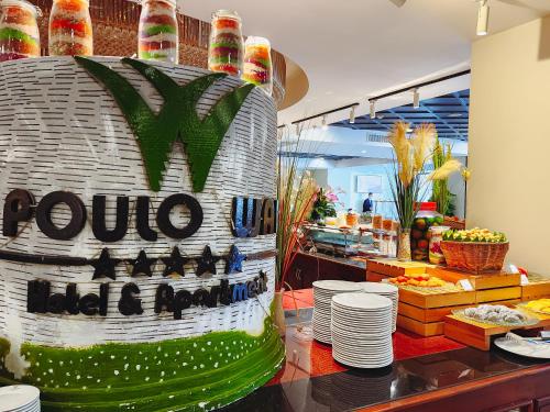 a table with a cake in front of a restaurant at Poulo Wai Hotel & Apartment in Phnom Penh