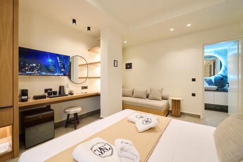 a hotel room with a bed and a desk at Monarco Executive Rooms in Rhodes Town