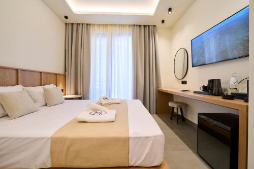 a hotel room with a bed and a desk at Monarco Executive Rooms in Rhodes Town