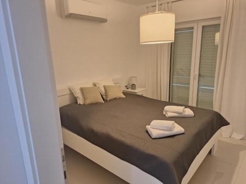 a bedroom with a bed with two towels on it at Residence SCOPA 2 in Poreč