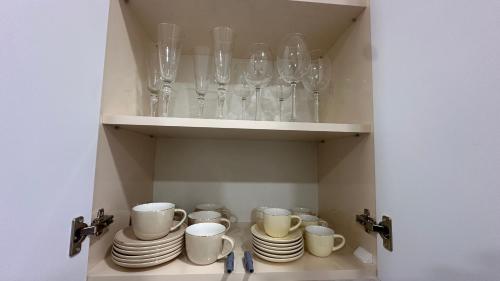 a cupboard filled with glasses and plates and cups at Lux Home in heart of city center in Vanadzor