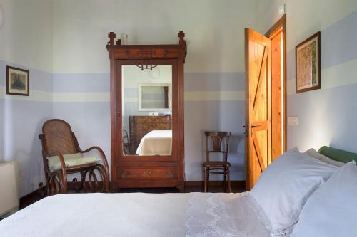 a bedroom with a bed and a large mirror at Saracina in Aci Catena