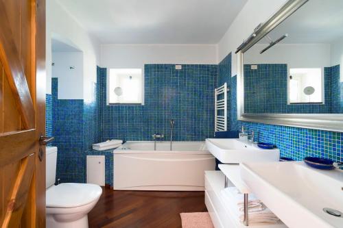 a bathroom with a tub and a sink and a toilet at Saracina in Aci Catena