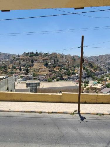 a pole on the side of a road next to a street at Loft Apartment Jabal Amman A in Amman