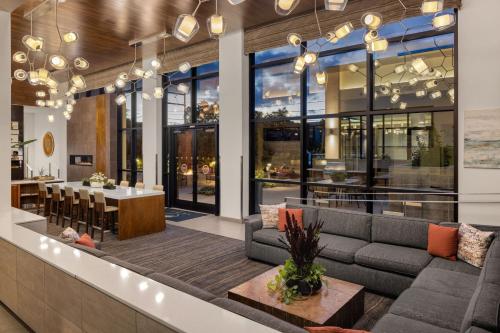 a lobby of a restaurant with a couch and a table at Element Bozeman in Bozeman
