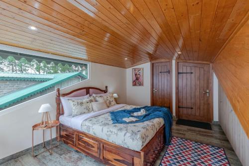 a bedroom with a bed and a wooden ceiling at ELIVAAS 3 BHK with Garden & Scenic Views - Alpenglow in Kasauli