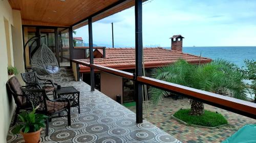 a balcony of a house with a view of the ocean at Our home in Chakvi