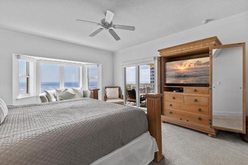 a bedroom with a bed and a ceiling fan at Atlantic Villas 301 in New Smyrna Beach