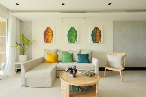 a living room with a couch and a table at Kata Views by SJ & MJ in Kata Beach