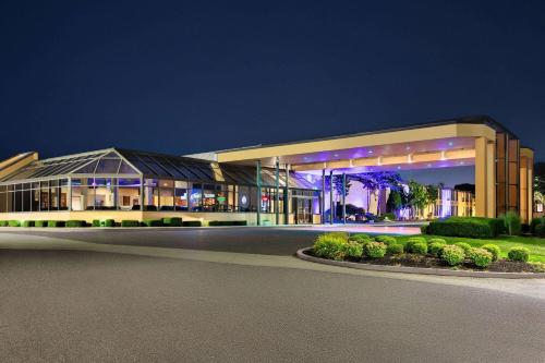 a large building at night with its lights on at Days Hotel by Wyndham Allentown Airport / Lehigh Valley in Allentown