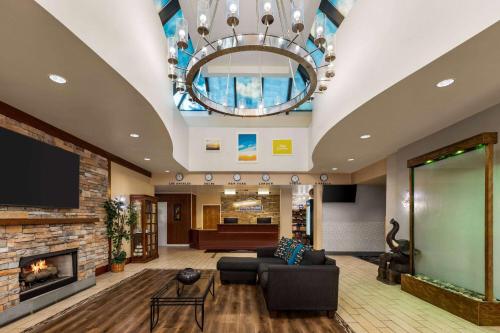 a living room with a couch and a fireplace at Days Hotel by Wyndham Allentown Airport / Lehigh Valley in Allentown