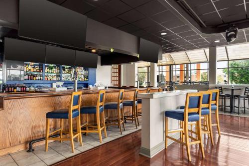 a bar with blue chairs at a restaurant at Days Hotel by Wyndham Allentown Airport / Lehigh Valley in Allentown