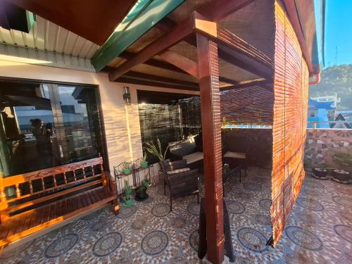 an outdoor patio with a fireplace on a house at Luxury Penthouse With View&Starlink in Dapa
