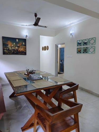 a dining room with a table and a ceiling at Best 3BHK Premium Homestay - Lapis, 7 Elysee Homestay in Trichūr