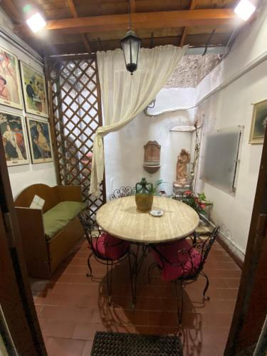 a table and chairs in a room with a couch at SWEETSUITE Rome in Rome