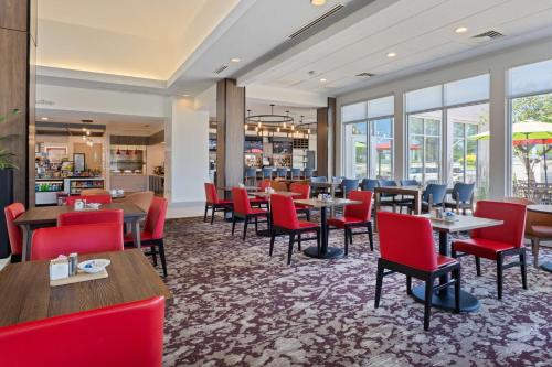 a restaurant with tables and chairs and windows at Hilton Garden Inn Chesterton in Chesterton