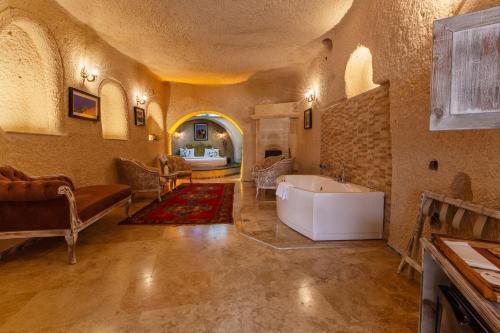 a large bathroom with a tub in a room at Karlık Cave Suite Cappadocia in Uchisar