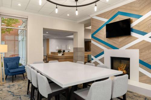 a conference room with a table and chairs and a fireplace at Hilton Garden Inn Spokane Airport in Airway Heights