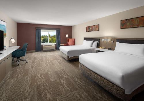 a hotel room with two beds and a television at Hilton Garden Inn Spokane Airport in Airway Heights