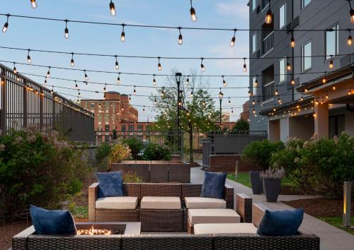 a patio with couches and a fire pit with lights at Hampton Inn & Suites-Worcester, MA in Worcester