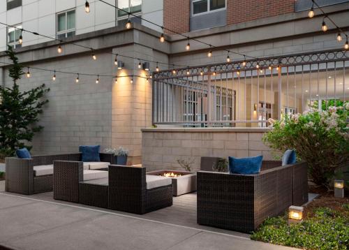 a patio with wicker furniture and a fire pit at Hampton Inn & Suites-Worcester, MA in Worcester