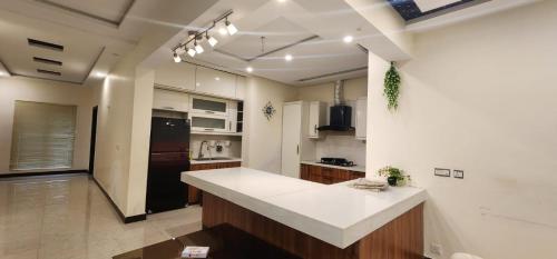 a kitchen with a large white counter top in a room at Haven Lodge - 7BR Luxury Vacation Home with Mountain View in Islamabad