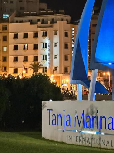 a sign for tamina marina in front of a building at Hotel Miramar in Tangier