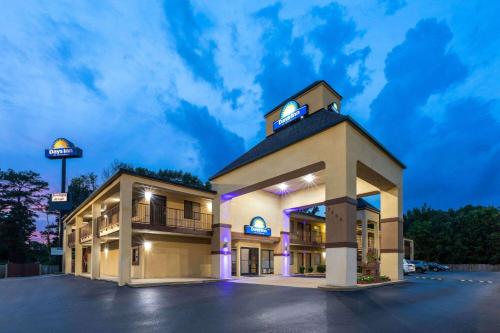 a hotel front of a building with a clock tower at Days Inn by Wyndham North Little Rock Maumelle in Maumelle