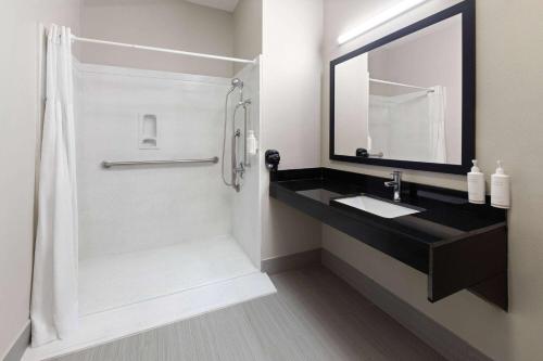 a bathroom with a sink and a shower at Days Inn by Wyndham North Little Rock Maumelle in Maumelle