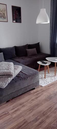 a living room with a couch and two tables at Apartman ISPOD DUGE LANA in Zlatibor