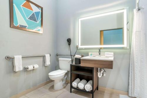 a bathroom with a toilet and a sink and a mirror at Comfort Inn Miramar Beach-Destin in Destin