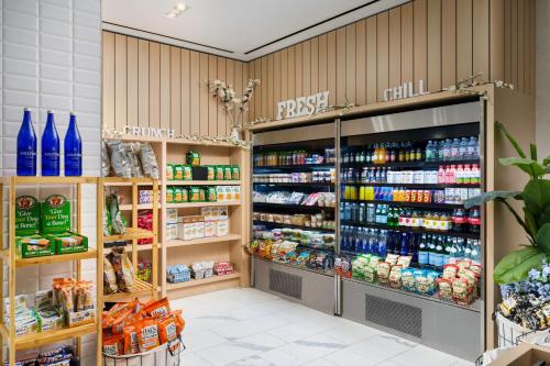 a grocery store aisle with a large amount of products at Hilton New York Times Square in New York