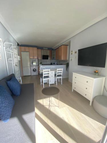 a living room with a couch and a table and a kitchen at Sweet home Salou in Salou