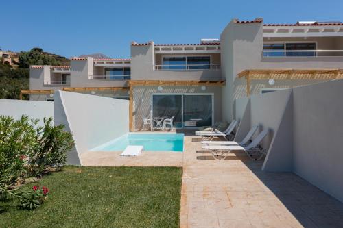 a view of a house with a swimming pool at Mythos villas in Damnoni