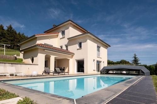 une villa avec piscine devant une maison dans l'établissement Gites des hauts de Jurieux Des activités pour tous !, à Sainte-Croix-en-Jarez