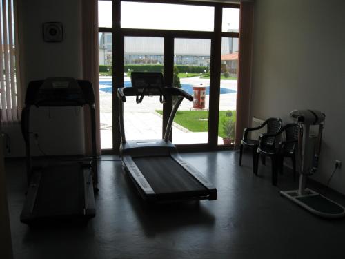 a gym with a treadmill and a large window at Hotel Grand in Samokov