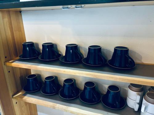 a row of blue vases on a shelf at SAMURISE No.4 in Fujikawaguchiko