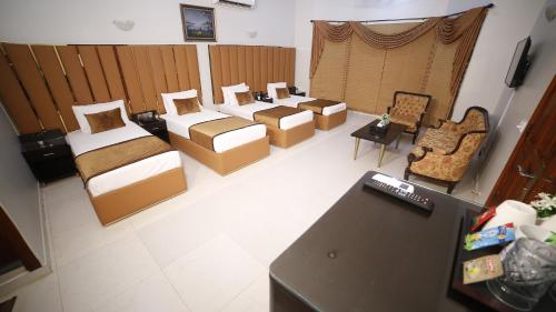 an overhead view of a room with beds and chairs at Four Squares by WI Hotel in Karachi